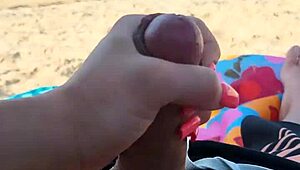 Public beach holiday turns into a steamy blowjob and handjob scene