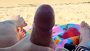 Public beach holiday turns into a steamy blowjob and handjob scene