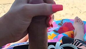 Public beach holiday turns into a steamy blowjob and handjob scene