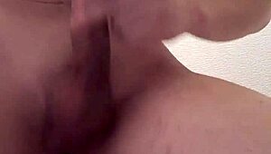 Muscular bodybuilder shoots massive load into glass in shower