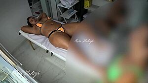 Hot brunette gets a massaging poolside in her bikini