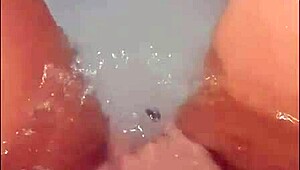 pretty woman teases in jacuzzi, masturbating to loud cumshot