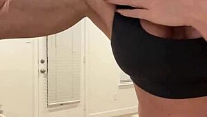 mature housewife bodybuilder flexing muscular body at home