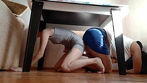 we’re hiding under the table from stepmom to rub our pussies together... so hot!! 😈