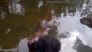 African girl bathes in river