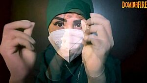 The latex-gloved femdom mistress dominates her submissive in a fetish session