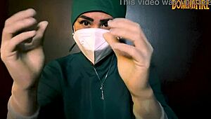 The latex-gloved femdom mistress dominates her submissive in a fetish session