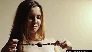 Muffling screams with ballgag during dildo use