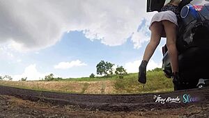 sluttish girl in short skirt flashes no panties opening car trunk on highway