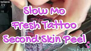 Slow motion fresh tattoo second skin peel with alternative fetish babe