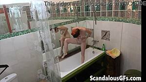 My redhead ex-girlfriend washes her shaved pussy with a showerhead in the bath. She shows off her curvy ass and glasses