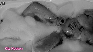 Kity Hudson plays with toy in steamy bath session