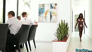 Hot ebony intern Noemie Bilas engages in various activities with colleagues at work, including deep conversations and physical interactions.