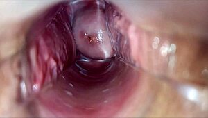 horny woman uses speculum for pulsating orgasm inside vagina.