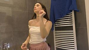 Are you seeing this braless hot brunette babe, all skinny and horny in her pink mini skirt, showing off that ass and legs in the bathroom?