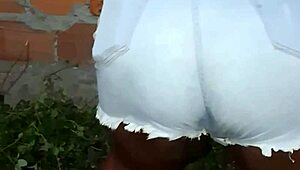 Neighbor with large buttocks cleans the backyard