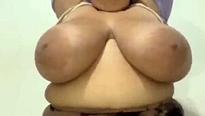 Curvy Latina woman showcases her massive tits in a subtle display.