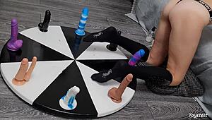 She spins the wheel of dildos to win her orgasm