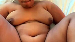 The chubby ebony babe moans as she takes the long black cock in missionary position.