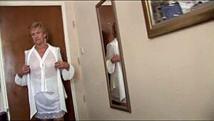 Naughty blonde granny flashes pussy under skirt in see-through top and slip