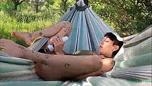 happy teen girl masturbates outdoors in a hammock in spain