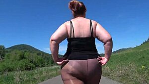 Mature bbw in nylon pantyhose and high heels walks public road. Foot fetish big booty asmr.