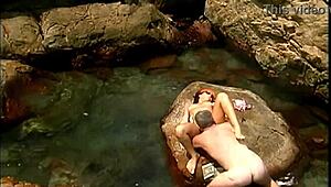 Does a mature man fuck an exotic babe on seaside stones?