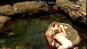 Does a mature man fuck an exotic babe on seaside stones?