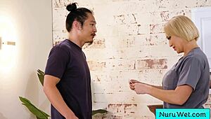 Sexy masseuse rubs big tits on client in nuru.