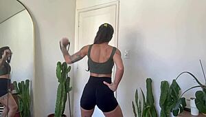 An inked girl warms up with rubber bands for her yoga fitness routine.