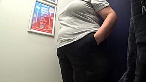 The camera watches a curvy milf change in satin panties