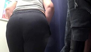 The camera watches a curvy milf change in satin panties