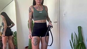 An inked girl warms up with rubber bands for her yoga fitness routine.