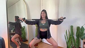 An inked girl warms up with rubber bands for her yoga fitness routine.