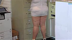 Big ass busty MILF with natural boobs in mini dress no panties flashes pussy in office close-up