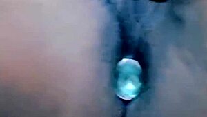 Mature woman standing in chastity cage with ripped clothes and thong