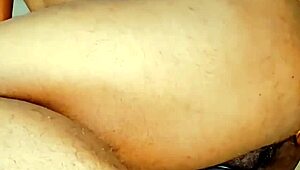 Mature woman standing in chastity cage with ripped clothes and thong