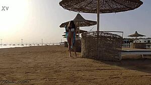 Young blonde goes pantyless on public beach