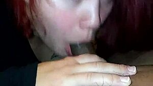 sexy redhead giving a blowjob
