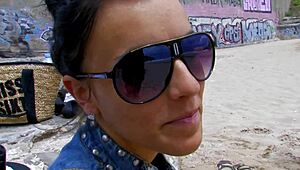 Short-haired tattooed woman relaxing on the beach