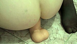 Anal orgasm brunette in stockings with a wide rubber dick masturbates juicy ass.