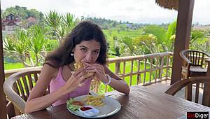 Cute girl feels excited eating burger with cum on face in public cafe