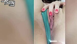 A petite 18+ teen girl masturbates fingering shaved pussy close-up in lingerie fishnets bent over