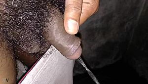 Indian stud pisses hot stream in bathroom stroking massive black cock to orgasm