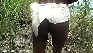 skinny african tribe girl labors outdoors in the wild