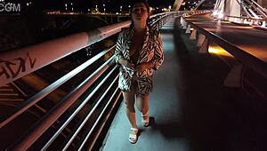 Luscious milf struts braless pantyless on bridge