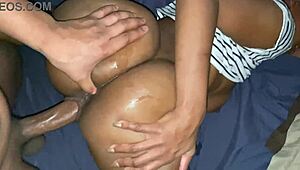 Playful couple cuddles intimately under soft sheets