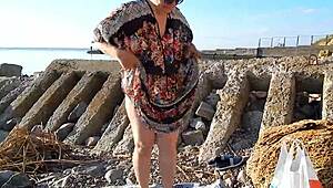 Hairy chubby mature flashes wet beaver under skirt on public nudist beach