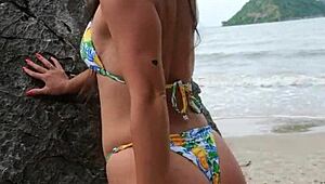 This petite tanned girl next door dances bikini on tropical beach, flashing ass casually