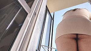 latina babe flashes shaved pussy and ass on balcony without panties